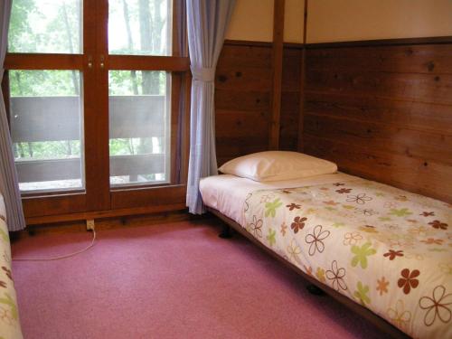 Postel nebo postele na pokoji v ubytování Hayashi Pension