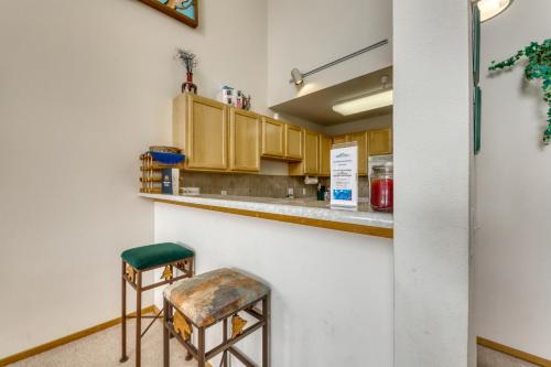 a kitchen with wooden cabinets and two stools at Cydney Ln 61C in Silverthorne