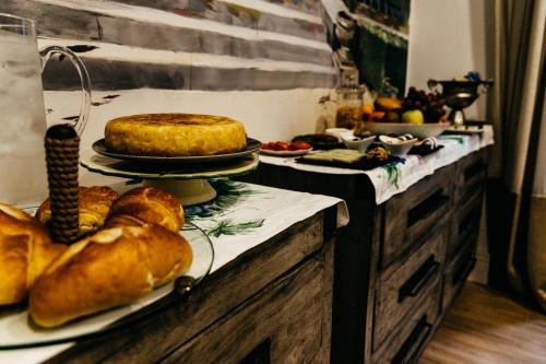 a table with bread and a cake on top of it at HOTEL LUZ ALMONASTER in Almonaster la Real