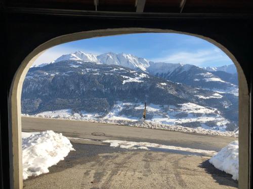 a view of a snowy mountain from an airplane window at Bijou Ladir in Ladir