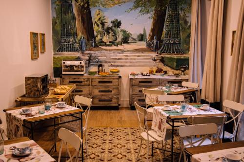 una cucina con tavoli e sedie e un dipinto sul muro di HOTEL LUZ ALMONASTER ad Almonaster la Real