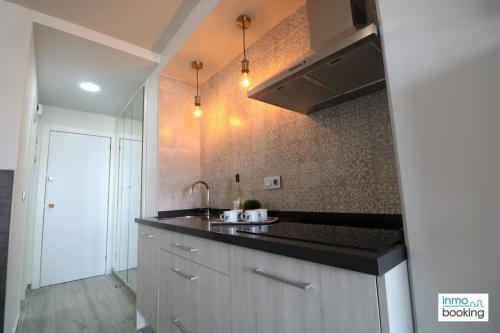 a kitchen with a sink and a counter top at Experience Internacional Salou - Climatizado con piscina in Salou
