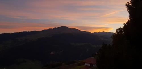 a view of a mountain with a sunset in the background at Bijou Ladir in Ladir