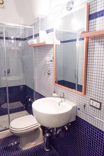 a bathroom with a sink and a toilet and a shower at Hotel Letizia in Orte