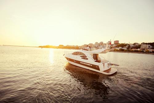 a boat sitting in the water on a lake at Porto Private Yacht- Accommodation Douro River in Porto