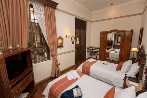 a hotel room with a large bed and a fireplace at Mansion Alcazar in Cuenca