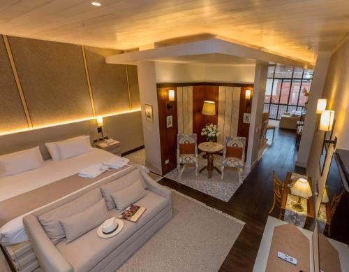 a bedroom with a large bed and a living room at Mansion Alcazar in Cuenca