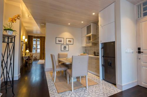 a kitchen and dining room with a table and a refrigerator at Mansion Alcazar in Cuenca