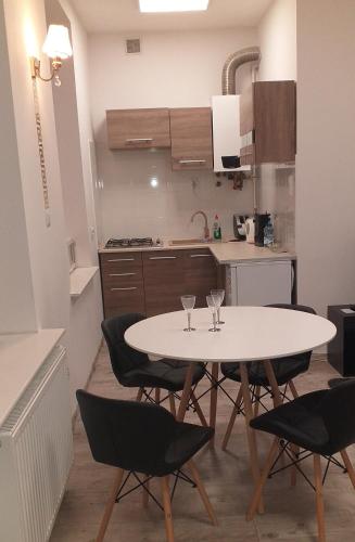 a kitchen with a table and chairs in a room at Apartament centrum Sienkiewicza WIEŻA EIFFLA PROMENADA -KLIMATYZACJA- WYJĄTKOWY in Kielce
