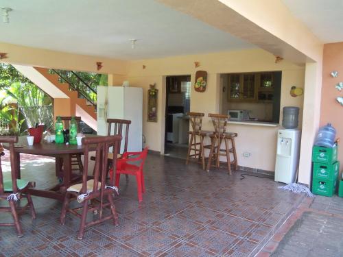 a room with a table and chairs and a kitchen at Army Village RD in La Piña