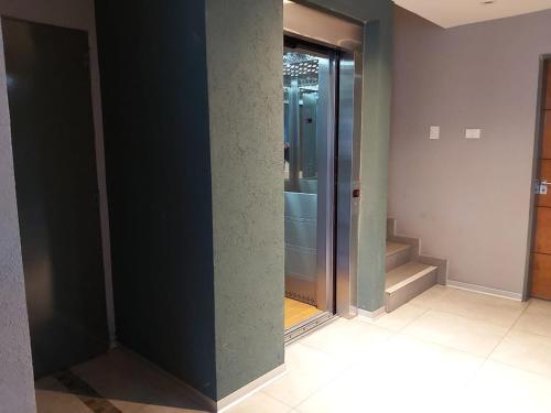 a hallway with a glass door in a building at Linda Vista en Adrogue in Adrogué