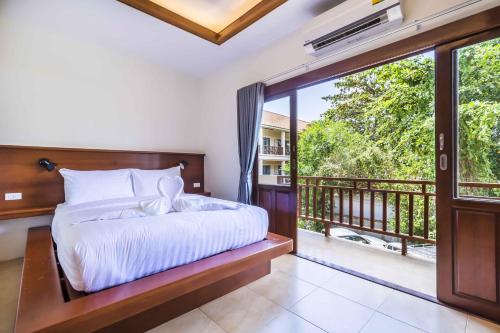 a bedroom with a bed and a balcony at Wyh Hotels in Ko Tao