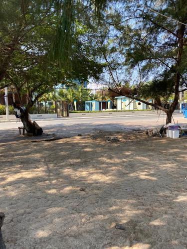 a park with a bench and trees on a street at Lumpini seaview cha-am By Greenview in Ban Sahakham