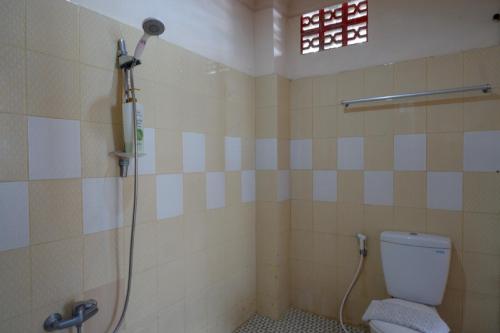 a bathroom with a shower and a toilet at RedDoorz near Kendari Beach 2 in Kendari