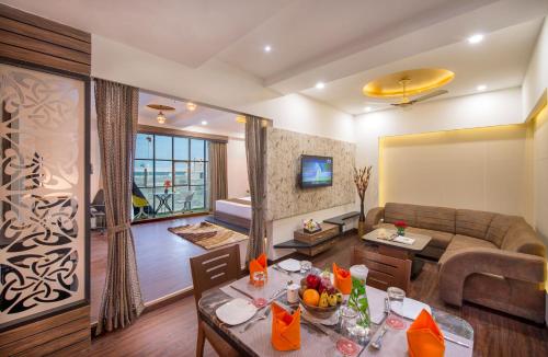 a living room with a couch and a table at Lords Eco Inn Morbi in Morbi