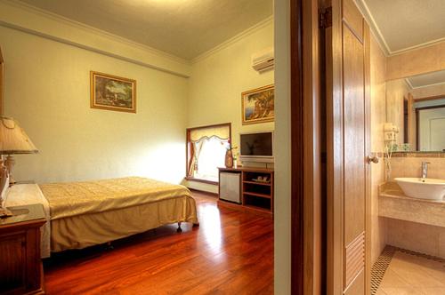 a bedroom with a bed and a bathroom with a sink at Aurora in Wujie