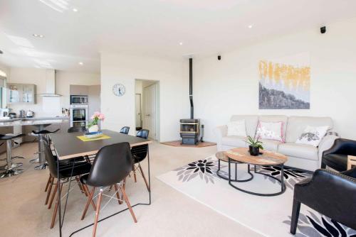 a living room with a couch and a table at Hilltop Getaway in Nelson