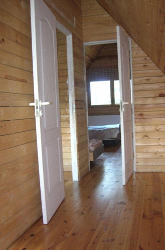 an empty room with an open door and wooden walls at Tera in Saulkrasti