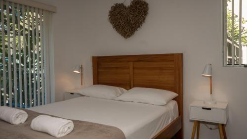 a bedroom with two beds and a heart on the wall at Sanctuary Lake Apartments in Gold Coast
