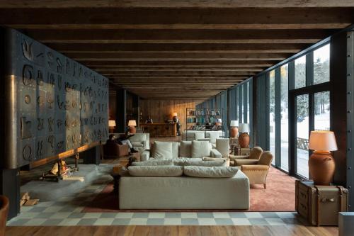a living room with a couch and a fireplace at Kokhta Bakuriani in Bakuriani