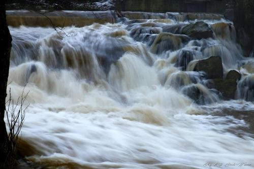 a group of rapids on a river with rocks at Ferienwohnung Mörlenbach in Mörlenbach