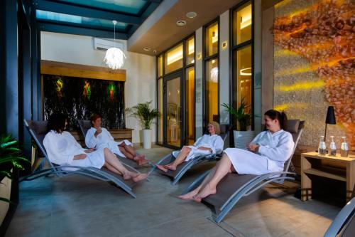 a group of women sitting in chairs on a patio at Ośrodek Uzdrowiskowy Biawena in Wysowa-Zdrój