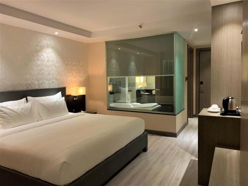 Ένα ή περισσότερα κρεβάτια σε δωμάτιο στο Capitol Hill Hotel and Suites