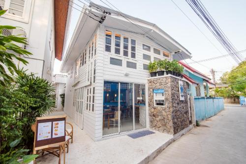 a white building with a restaurant on a street at Baan KangMung Hua Hin On The Beach in Hua Hin