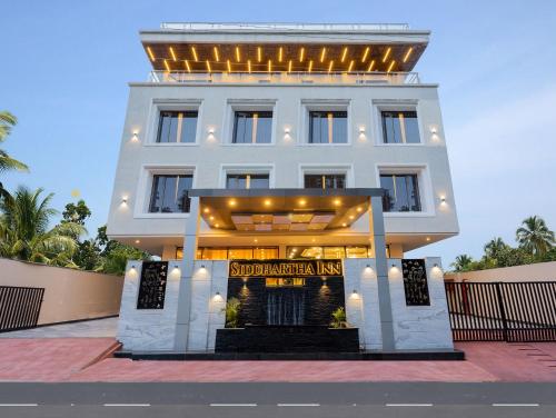 a white building with a sign in front of it at Hotel Siddhartha Inn in Udaipur