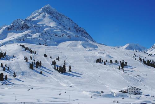a snow covered mountain with people skiing on it at Landhaus Notburga in Gries im Sellrain