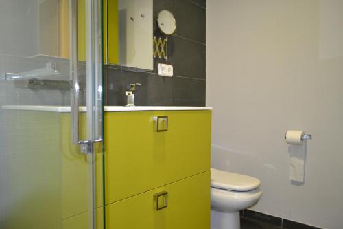 a bathroom with a yellow cabinet and a sink at SAMSA House in Águilas