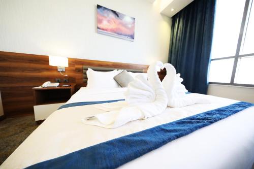 a hotel room with a bed with towels on it at Eva Hotel in Jeddah
