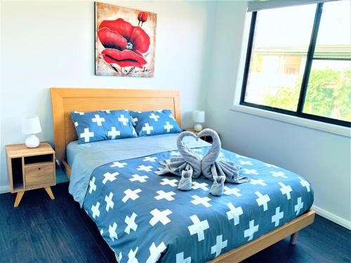 a bedroom with a bed with swans on it at Revesby New Self Contained Granny Flat in Revesby