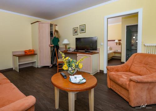 a living room with a couch and a table at Flairhotel am Wörthersee in Velden am Wörthersee