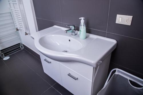 a bathroom with a white sink and a mirror at Mazzini Privè in Caserta