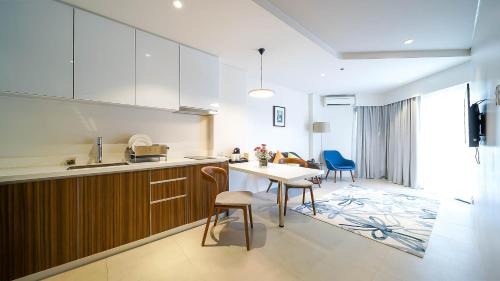 a kitchen with a table and chairs and a dining room at Tambuli Seaside Resort and Spa in Mactan