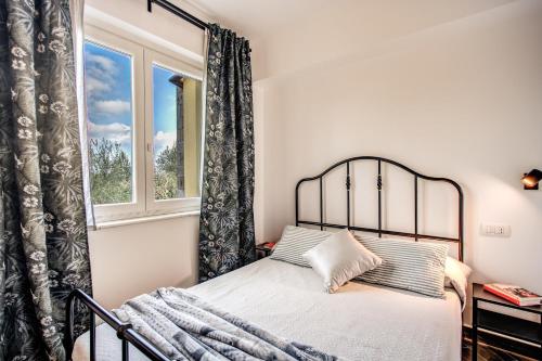 un dormitorio con una cama y una ventana en CHEZ MARIE' - modern apartment in countryside, en Sorrento