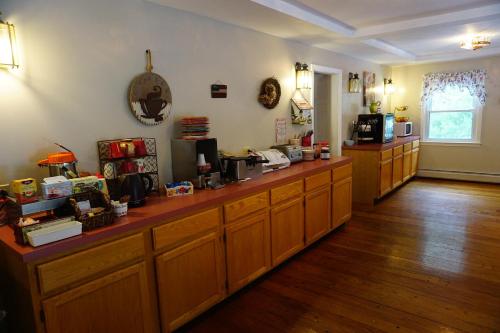 a kitchen with wooden cabinets and a counter at Stay Berkshires in Williamstown