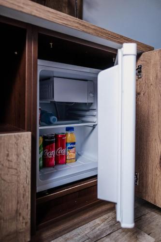 an open refrigerator with food and drinks in it at Penzion Prestige Tennis Park in Frýdek-Místek