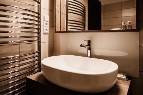 a bathroom with a white sink and a mirror at Penzion Prestige Tennis Park in Frýdek-Místek