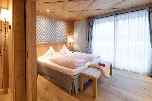a bedroom with a large bed and a window at Landhaus am Stein in Bad Wiessee