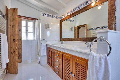a bathroom with a sink and a mirror at Finca La Salve in Pollença