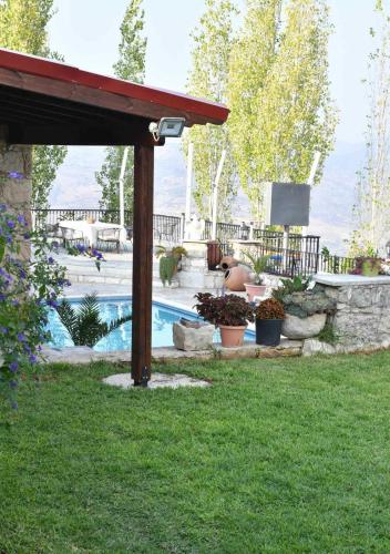 a backyard with a pool and a pergola at Lasa Black Rock villa in Paphos City