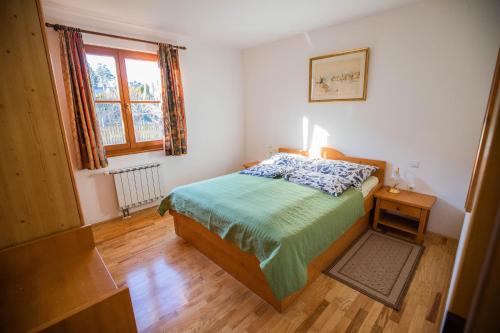 a small bedroom with a bed and a window at Apartment Jurič in Maribor
