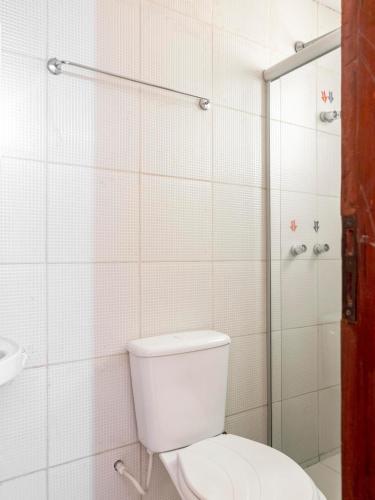 a bathroom with a toilet and a shower at Pousada Veleiro in Fortaleza