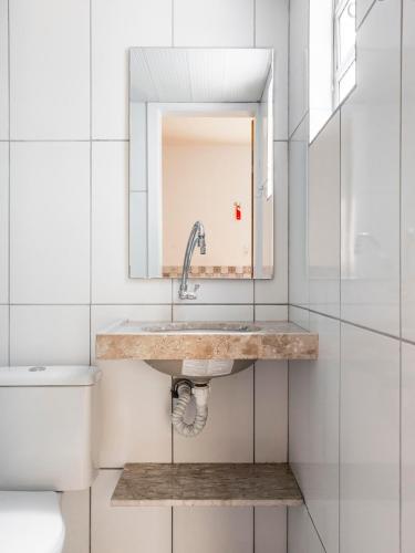 a bathroom with a sink and a toilet at Pousada Veleiro in Fortaleza