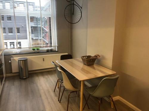 a dining room with a table and chairs and a window at Claire et Liège, toute une histoire... in Liège