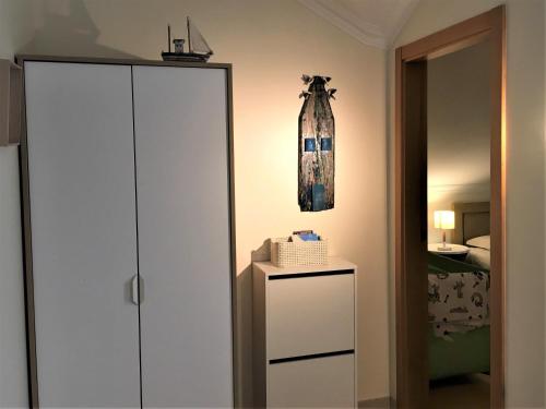 a bedroom with a white cabinet and a bed at Casas do Mar - Baleal 2 - Sea House in Baleal