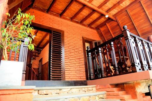a building with a balcony with a metal railing at D Family Resort in Anuradhapura