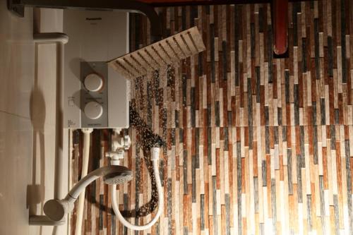a shower with a shower head in a bathroom at D Family Resort in Anuradhapura